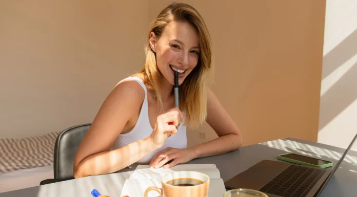 djevojka s laptomom sijedi na teraci uz kroasane i kavu